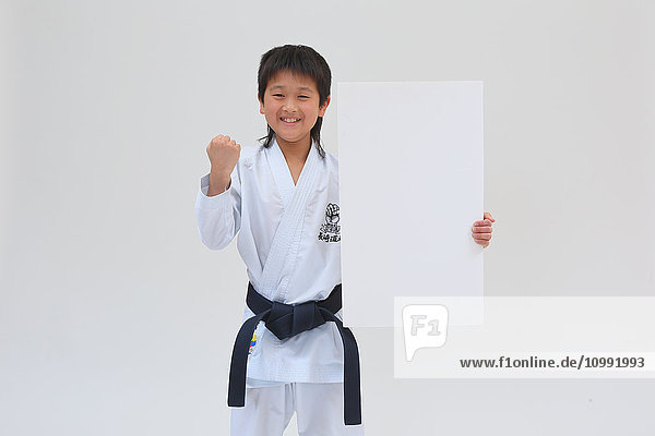 Japanese kid in karate uniform on white background