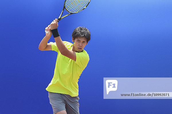 Young Japanese tennis player in action