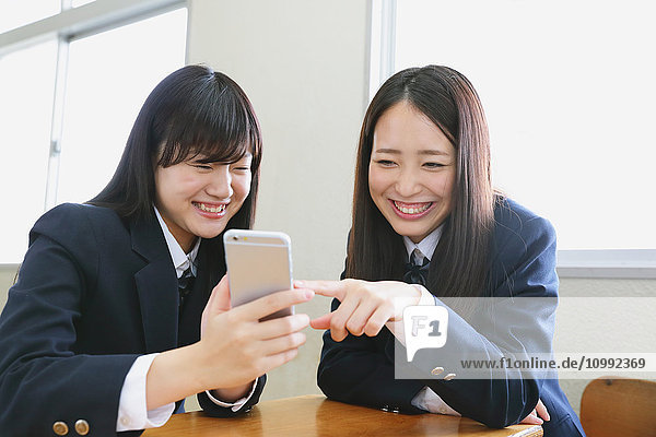 Japanese high-school students with smartphone in classroom