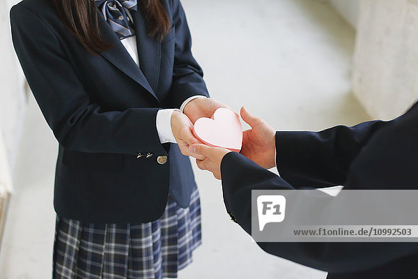 Japanese high-school student giving present