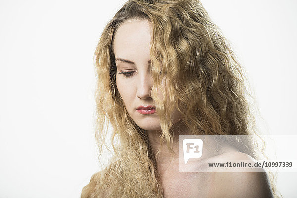 Portrait of beautiful woman with long  blond  curly hair