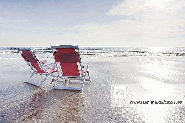 Maine  Red deckchairs on empty beach