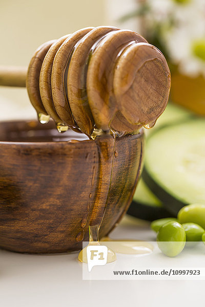 Honey dipper on bowl with honey