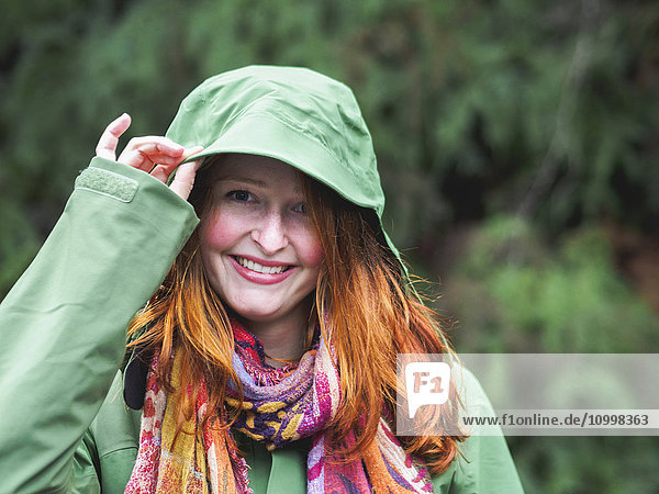 Portrait of smiling redhead in green jacket