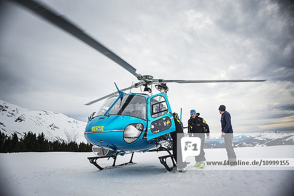 Reportage with a ski patrol team at the Avoriaz ski resort in Haute Savoie  France. The team are responsible for marking out the ski slopes  providing first aid to skiers  evacuations on the slopes as well as off piste and controlled avalanches. The patrol team evacuate a woman by helicopter who is injured.