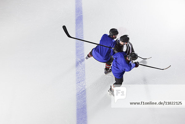 Hockey players blocking opponent on ice