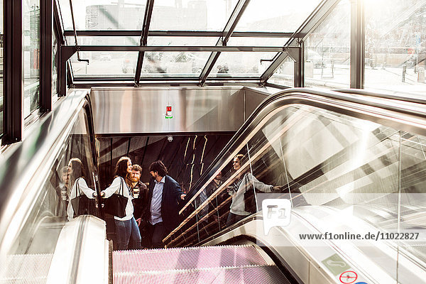 Business people on escalator at central station