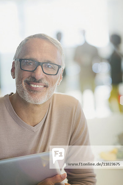 Portrait smiling businessman with digital tablet