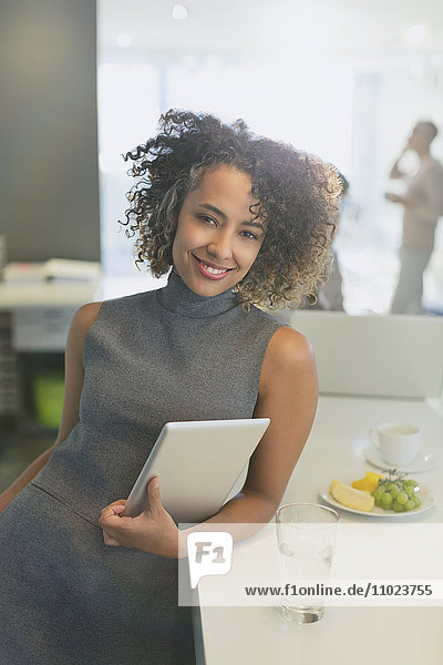 Portrait smiling businesswoman with digital tablet