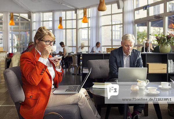 Businesswoman having coffee during business meeting