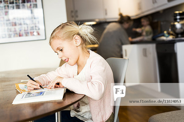 Girl studying on table at home