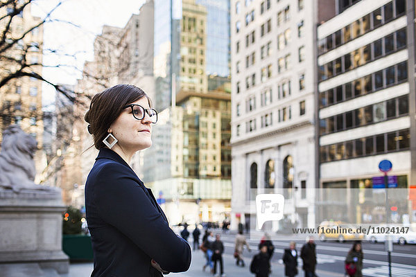 Side view of businesswoman waiting outside New York Public Library