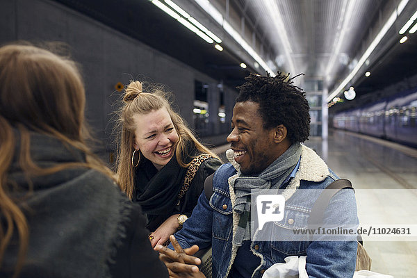 Happy friends enjoying at subway station