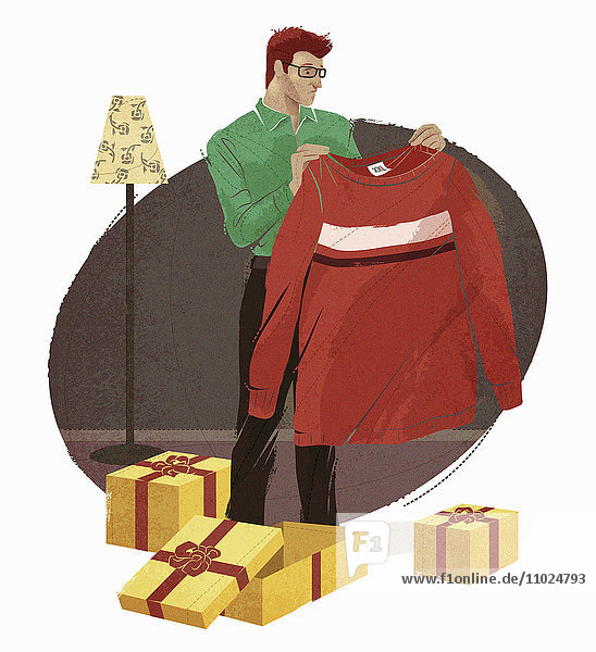 Mann öffnet Geschenke und ist enttäuscht von übergroßem Pullover