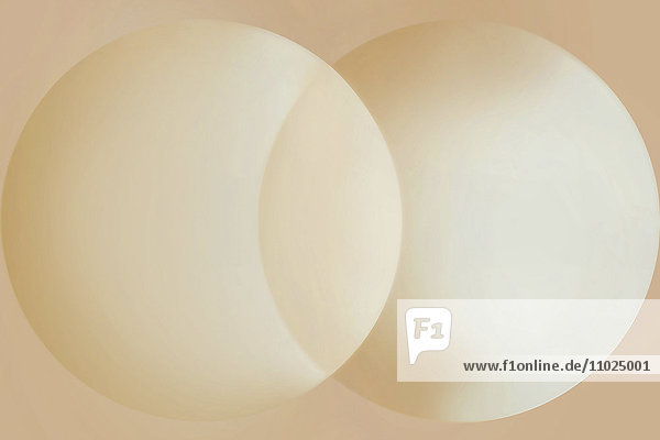 Abstraktes pfirsichfarbenes Muster zweier überlappender Kreise