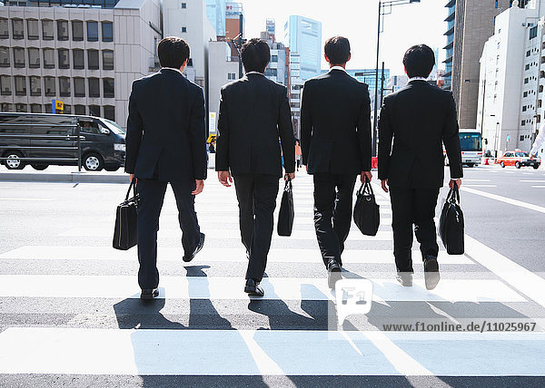 Young Japanese businessmen walking