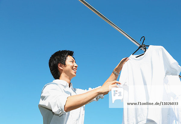Young Japanese man doing laundry