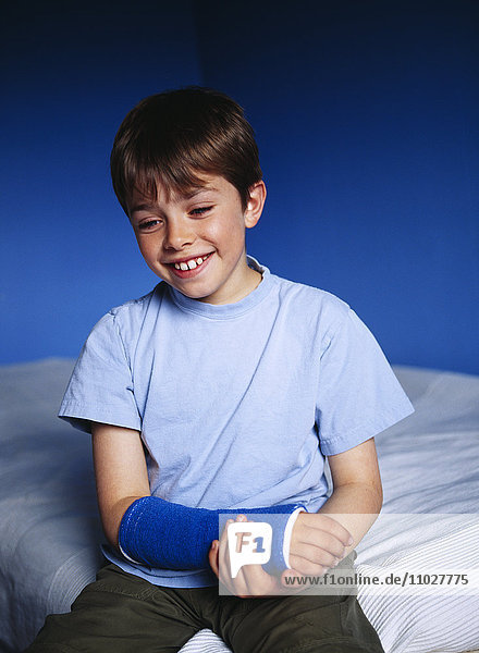Boy with his arm in a plaster.