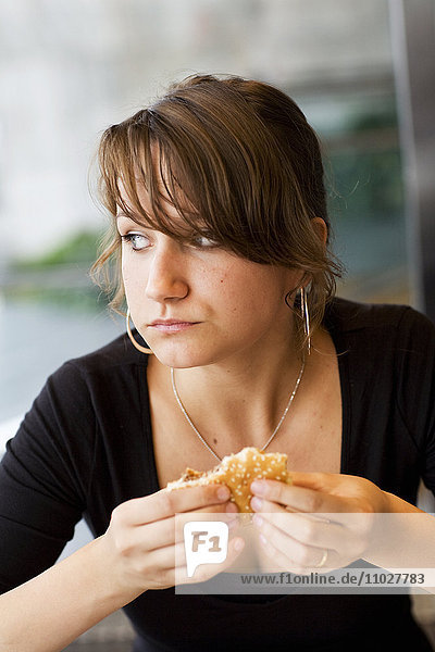 Frau beim Essen eines Hamburgers