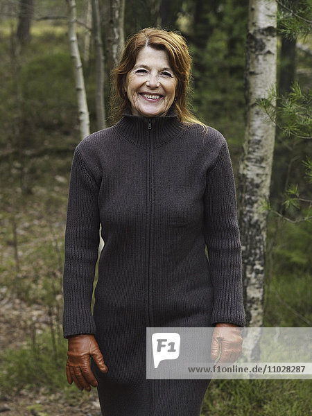 Sweden  Stockholm  portrait of woman standing in forest