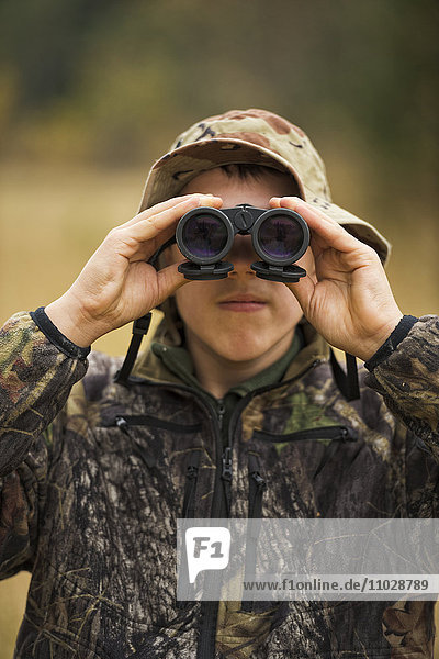 Teenager with binoculars