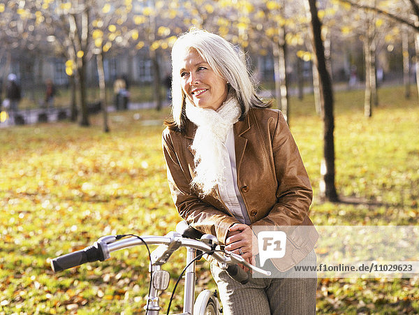 Porträt einer Frau mit Fahrrad.
