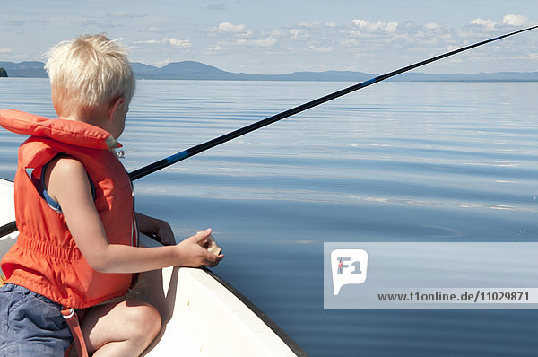 Boy fishing on boat