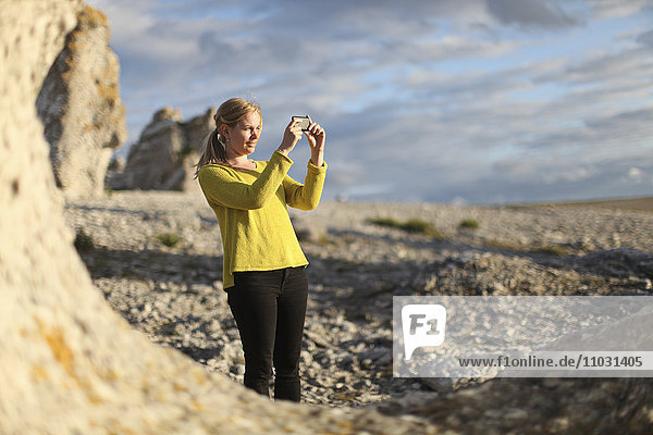 Woman taking pictures  Faro  Gotland  Sweden