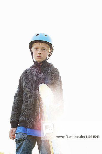 Portrait of boy holding skateboard
