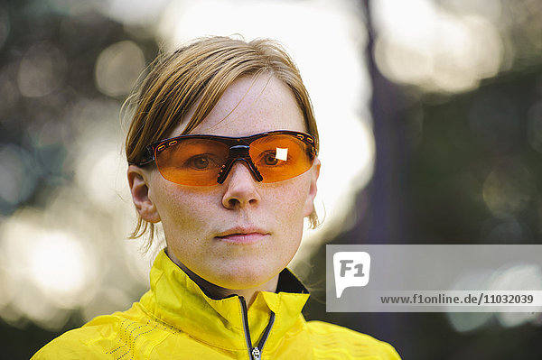 Portrait of female jogger wearing sunglasses