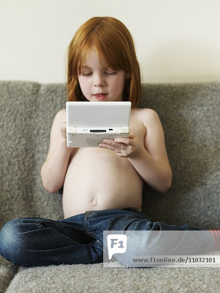 Girl playing with games console