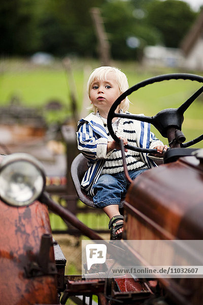 Portrait of baby boy on tractor