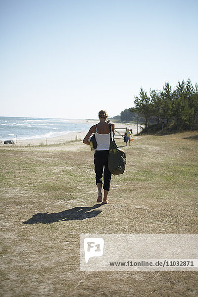 A woman going to the beach.