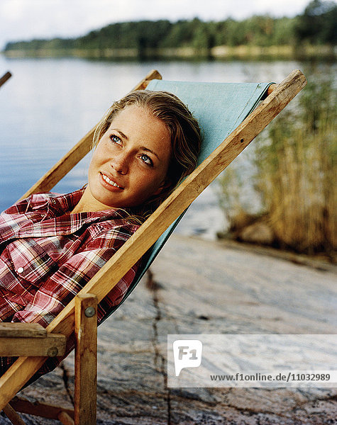 A young woman in a sun chair.