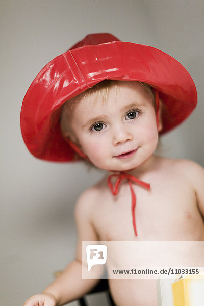 Studio portrait of boy wearing red hat