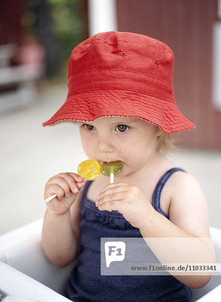 A girl eating lollipops  Sweden.