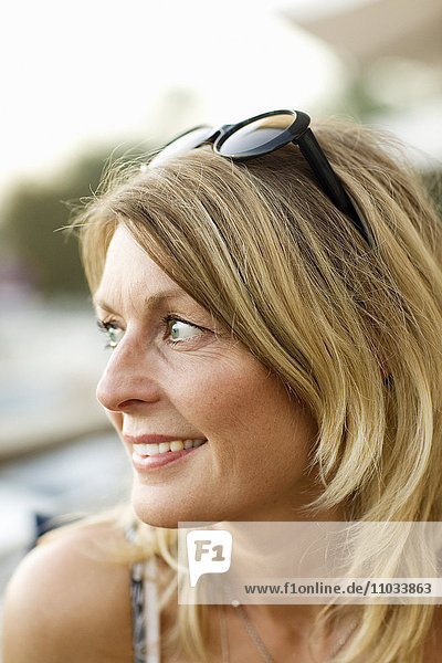 Portrait of a blond woman with sun glasses.