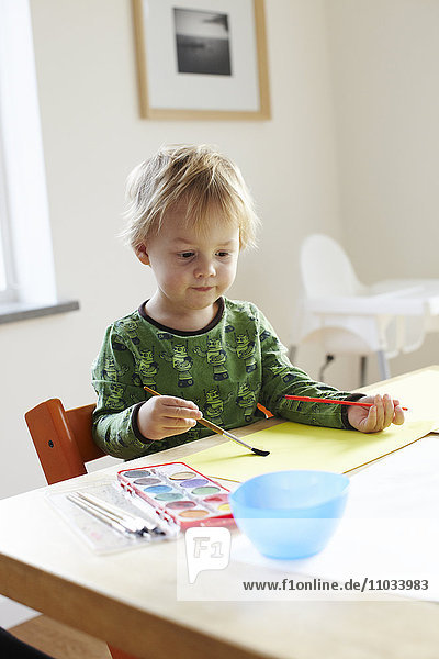 Boy sitting and painting