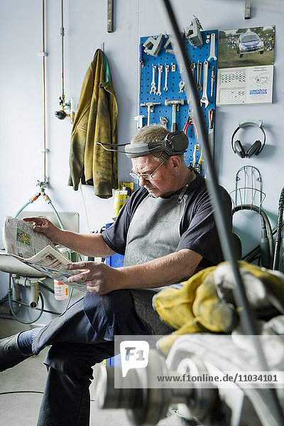 Mature man having break in workshop