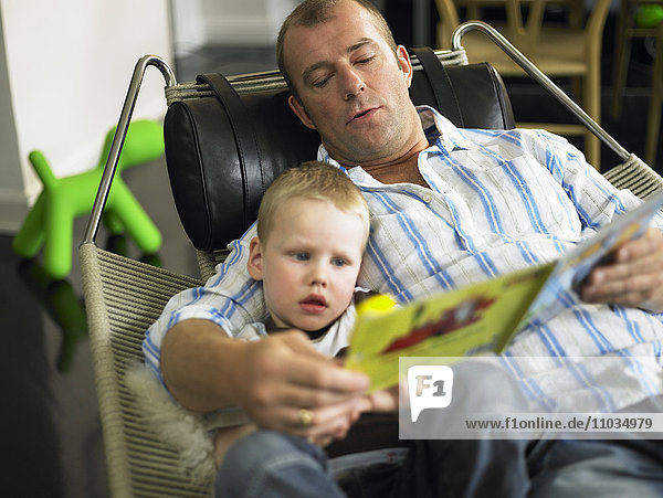 Father and son reading together.