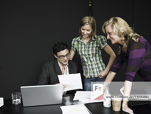 Three people in an office.