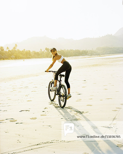 A Scandinavian woman riding a mountainbike.