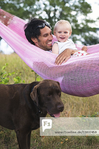Father and small child in a hammock  Sweden.