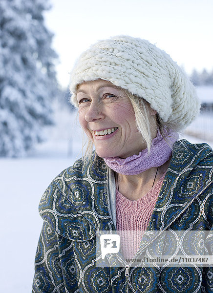 Portrait of a woman against a wintry landscape  Sweden.