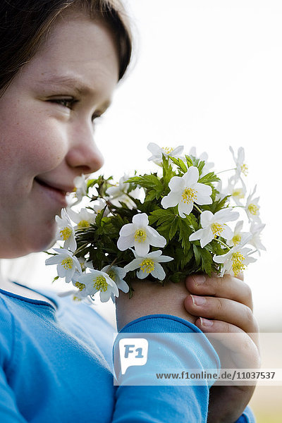 Girl with a nosegay of wood anemones  Sweden.