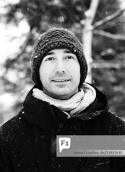 Portrait of a man in a wintry forest  Norway.