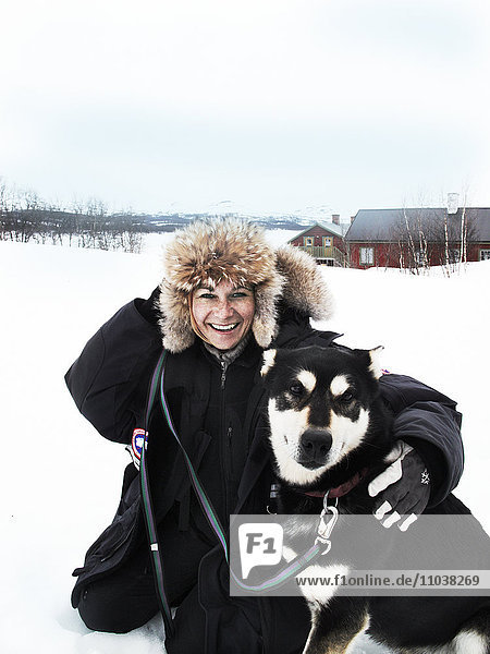 Woman with a dog in the snow  Sweden.