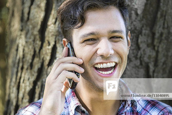 Man having lighthearted conversation on cell phone