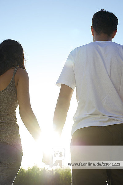 Couple holding hands taking walk together