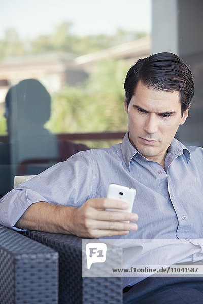 Man text messaging with smartphone